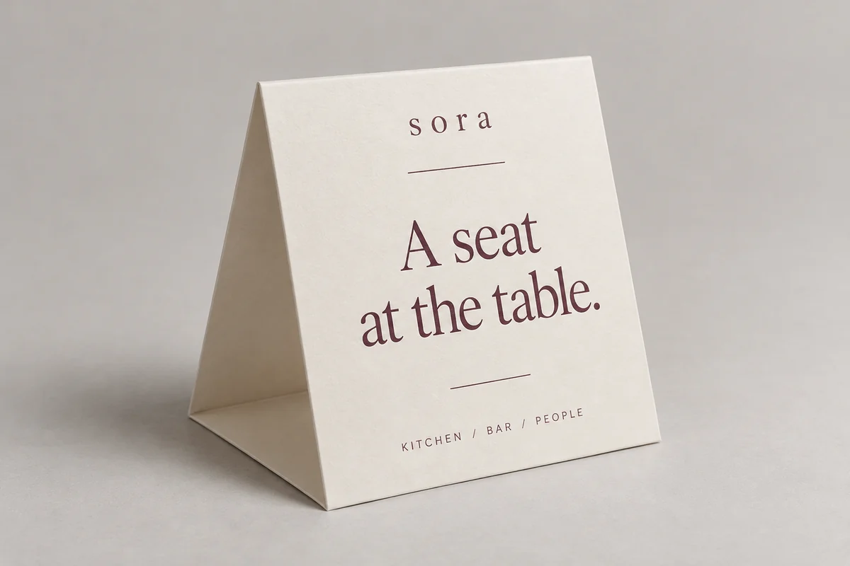 Sora table tents photographed on a soft neutral studio background